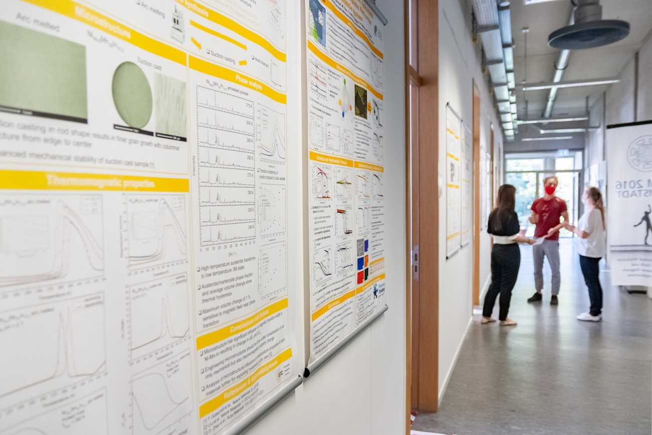 posters on the hallway with distinct people discussing